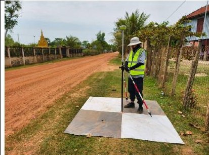Surveyor observing a ground control point with a GNSS rover